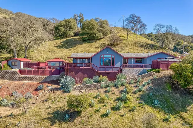a view of a chairs and table in the roof deck