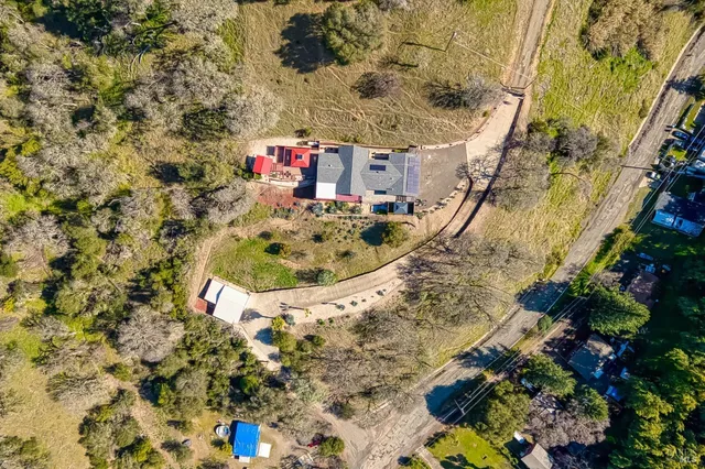 a living room with furniture a wooden floor and next to a window