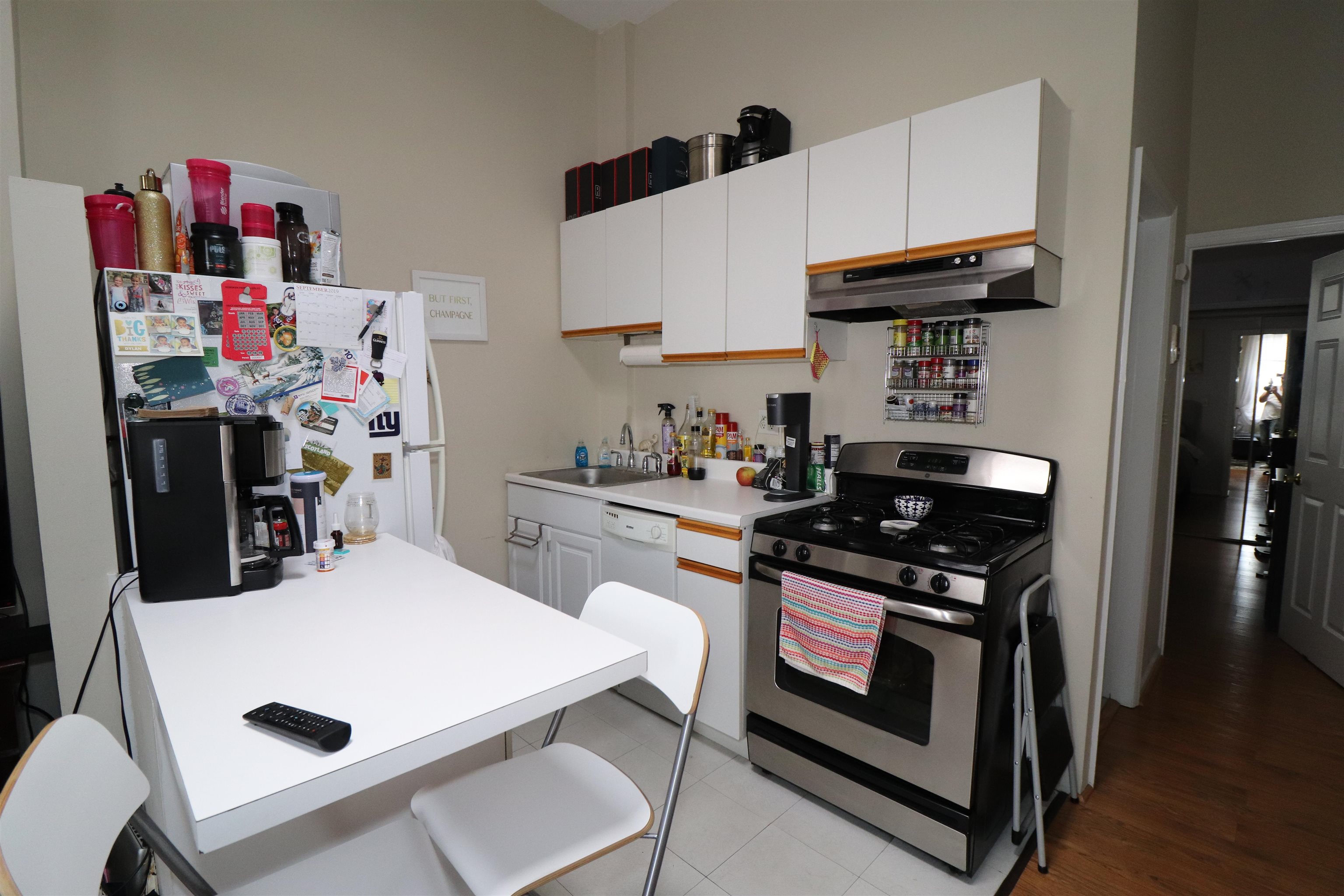 308 8th Street, Unit 2 Hoboken, NJ 07030 - Photo 2 of 8 a kitchen with stainless steel appliances a stove a table and chairs