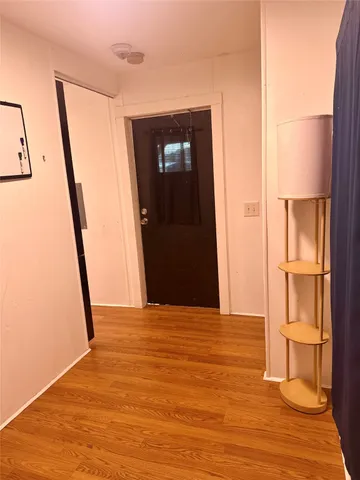 a view of an empty room with wooden floor