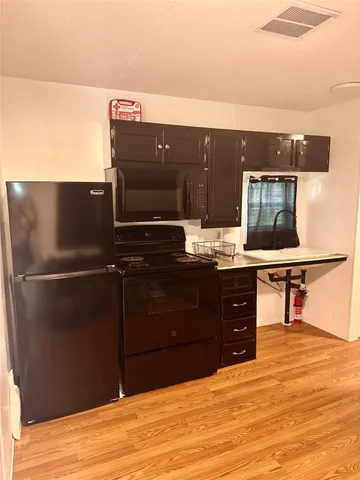 a room with a cabinets and wooden floor
