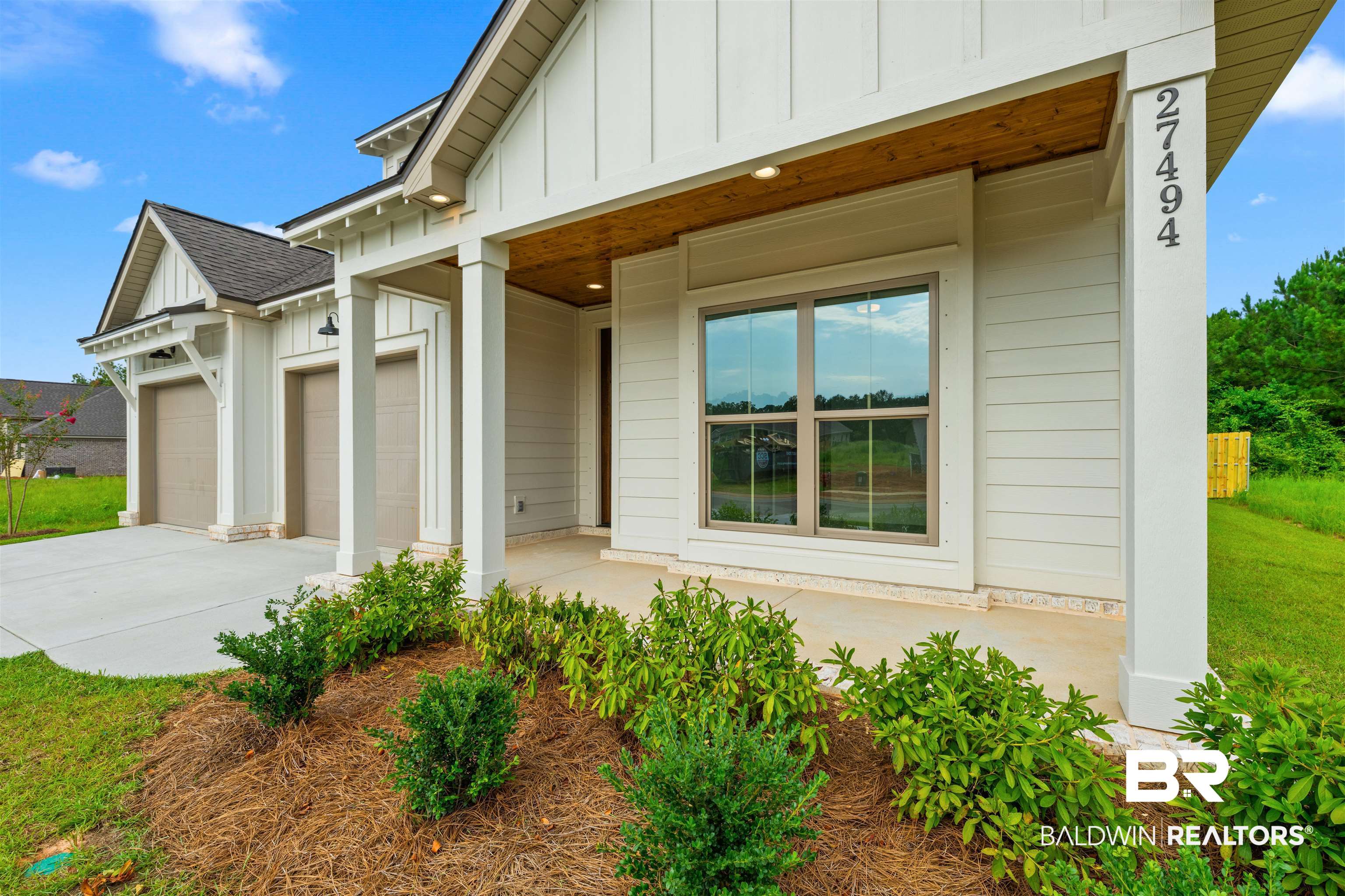 27494 Patch Pl Loop Daphne, AL 36526 - Photo 4 of 26 Modern farmhouse-style exterior featuring white horizontal siding and vertical board and batten accents