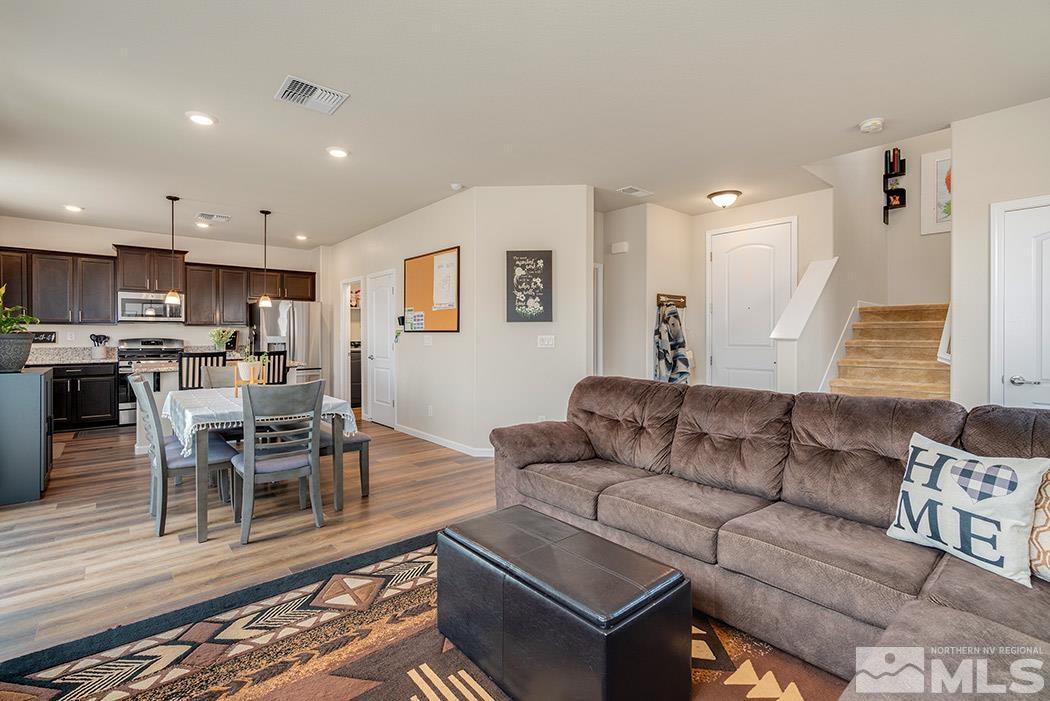 2395 Soprano Reno, NV 89521 - Photo 5 of 27 a living room with furniture and a dining table with kitchen view