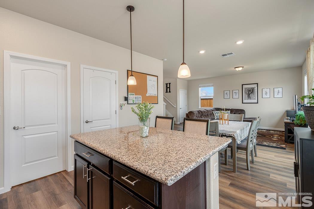 2395 Soprano Reno, NV 89521 - Photo 9 of 27 a kitchen with granite countertop kitchen island white cabinets and center island
