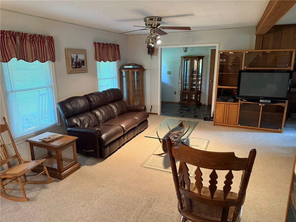 4027 Belhaven Road Belton, SC 29627 - Photo 9 of 24 A well-lit living area features comfortable seating and easy access to an adjacent room.
