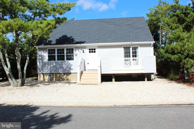 a view of a house with snow on the road