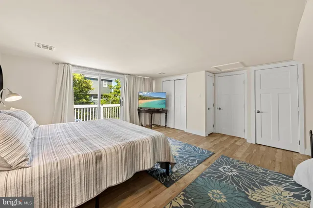 a view of a patio with table and chairs with wooden floor and fence