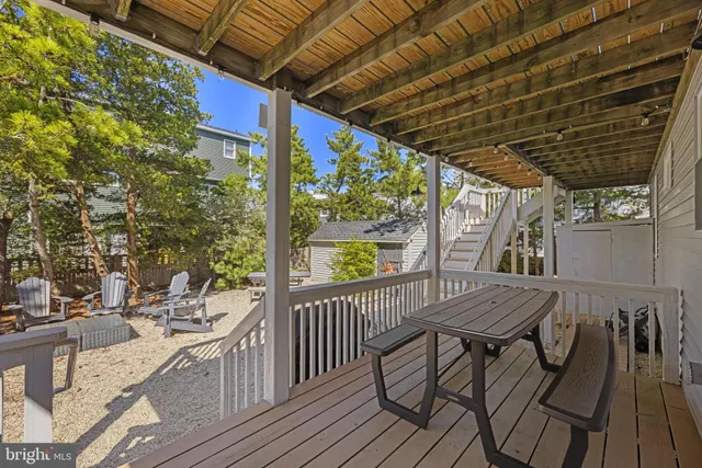 a view of a patio with a table and chairs and a floor to ceiling window