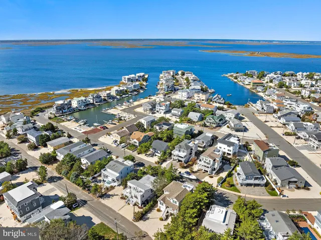 a living room with furniture a flat screen tv and a floor to ceiling window