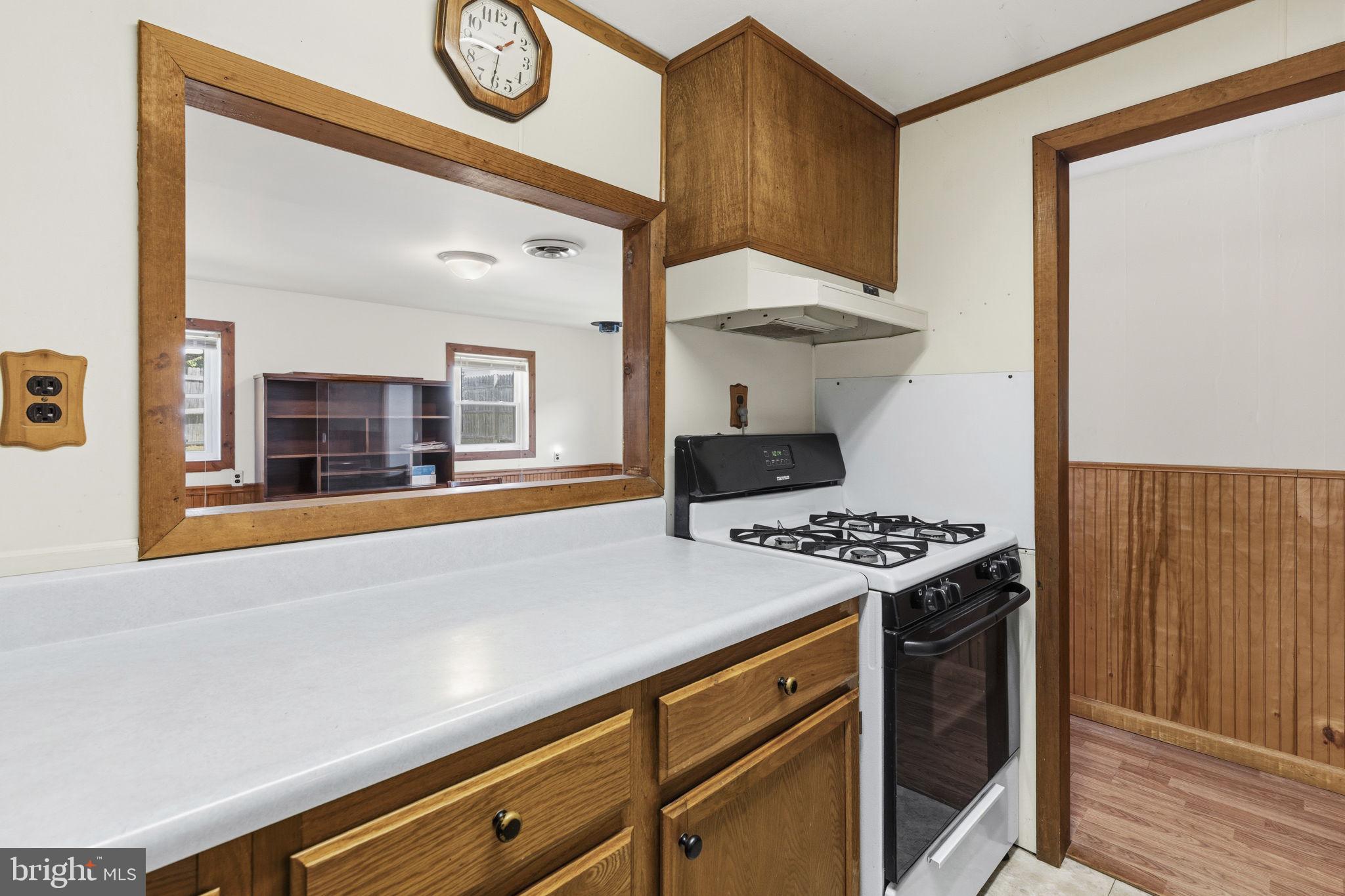 2411 Poplar Road Baltimore, MD 21221 - Photo 18 of 36 a kitchen with a stove and a wooden floor