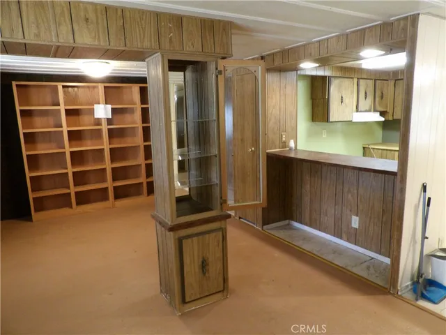 a view of a kitchen with fridge and hallway