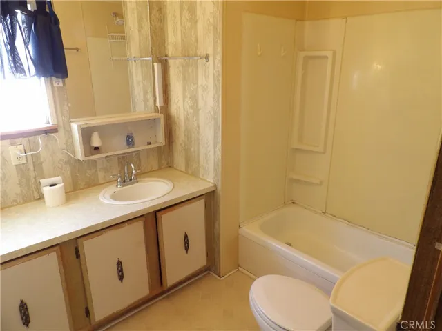 a white toilet sitting next to a shower