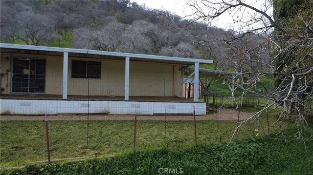 an aerial view of a house with a yard and lake view