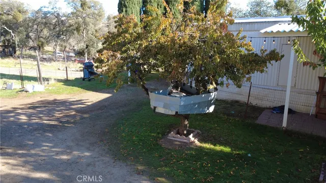 a backyard of a house with lots of trees