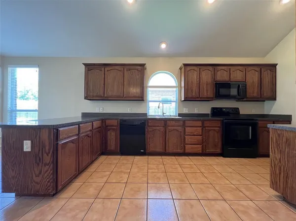 a kitchen with a refrigerator and a sink