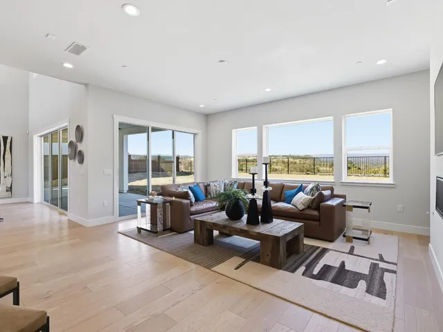 a living room with furniture and large windows