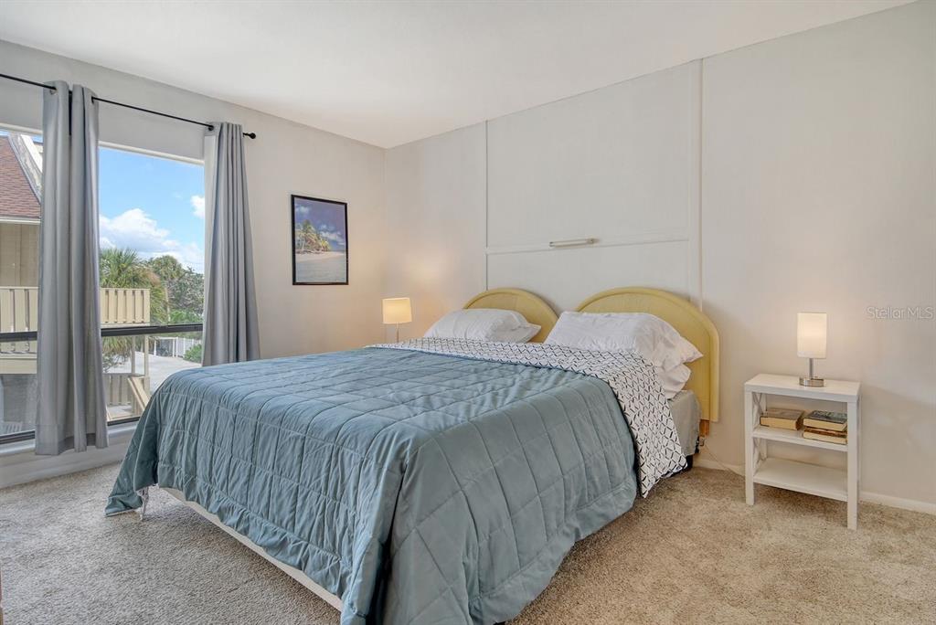 6157 Midnight Pass Road, Unit E63 Sarasota, FL 34242 - Photo 24 of 61 a bedroom with a bed and a window