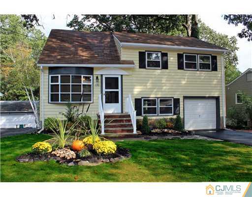 176 Kimberly Road Colonia, NJ 07067 - Photo 1 of 22 a front view of a house with a yard and potted plants