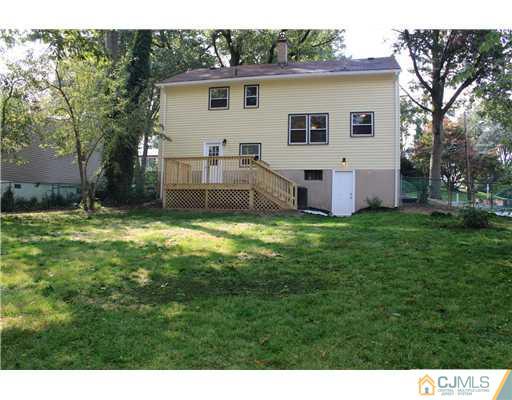 176 Kimberly Road Colonia, NJ 07067 - Photo 21 of 22 a view of a house with a big yard with potted plants and large tree