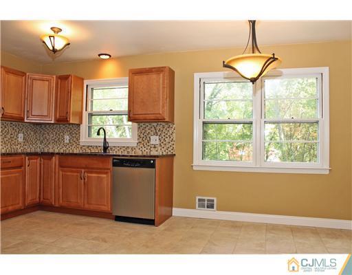 176 Kimberly Road Colonia, NJ 07067 - Photo 6 of 22 a kitchen with granite countertop a sink cabinets and window