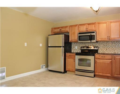 176 Kimberly Road Colonia, NJ 07067 - Photo 7 of 22 a kitchen with a refrigerator stove and microwave