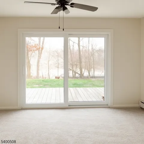 an empty room with wooden floor and a window