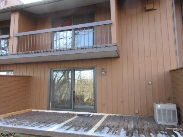 a view of a livingroom with wooden floor and a window