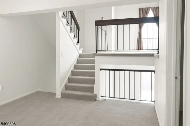 a view of staircase with rug