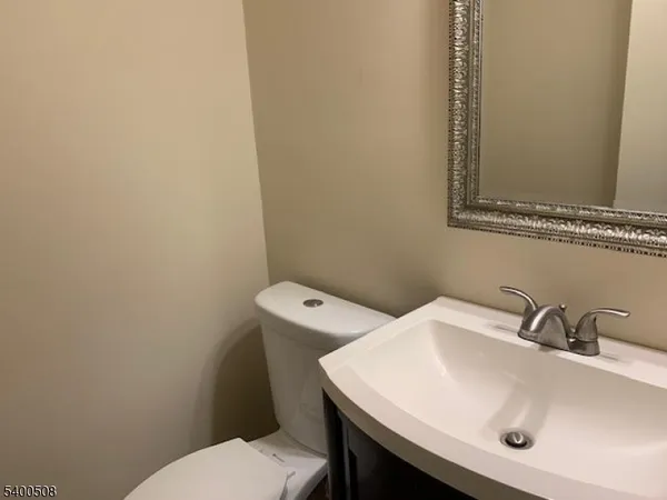 a bathroom with a sink a toilet and mirror