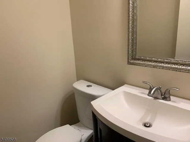 a bathroom with a sink a toilet and mirror