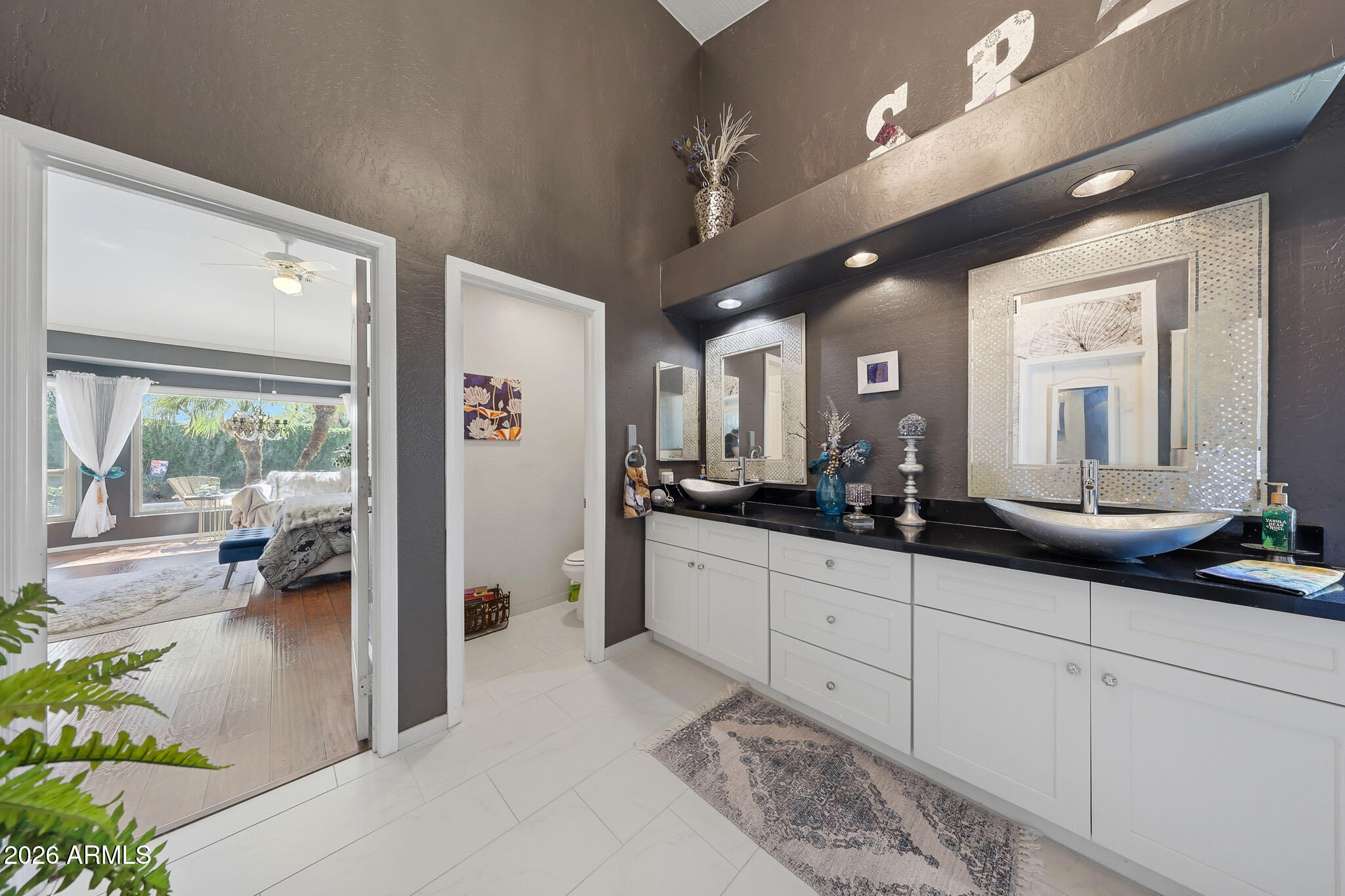 3897 East Cullumber Street Gilbert, AZ 85234 - Photo 25 of 51 a spacious en suite bathroom with a granite countertop sink mirror and vanity