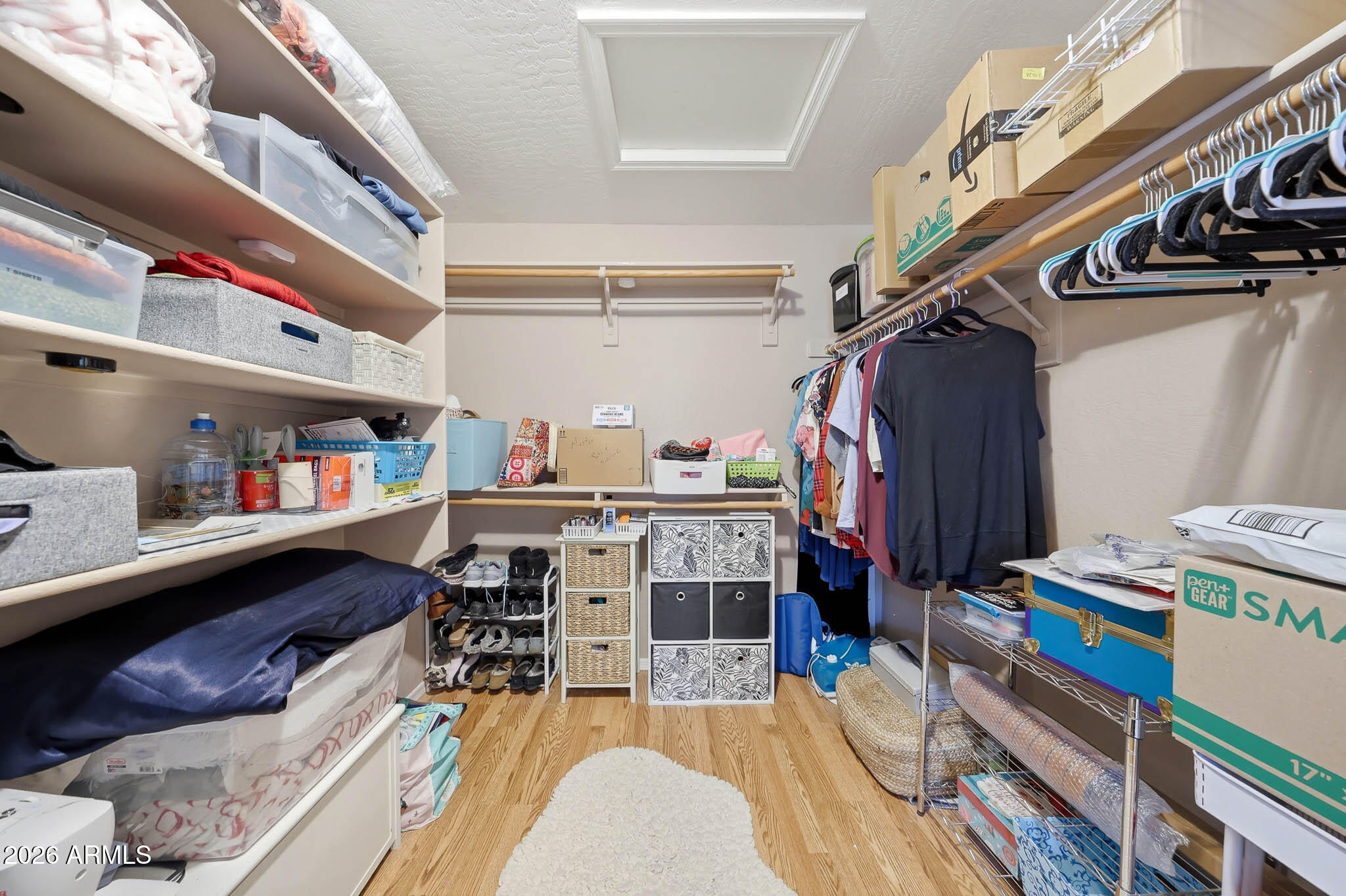 3897 East Cullumber Street Gilbert, AZ 85234 - Photo 26 of 51 a view of walk in closet with clothes and shoes