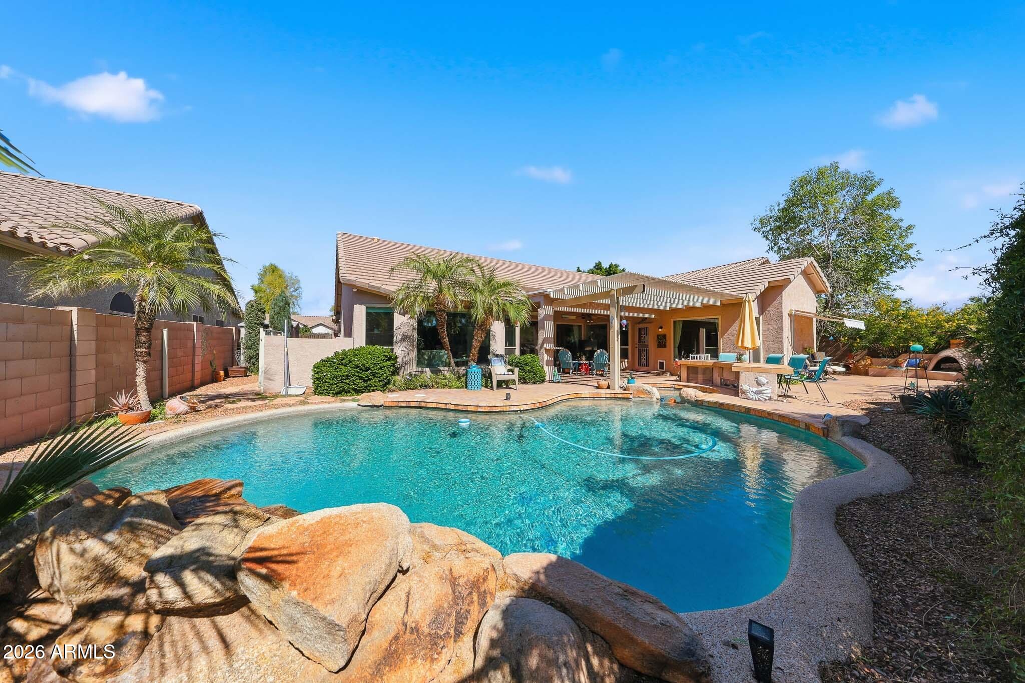 3897 East Cullumber Street Gilbert, AZ 85234 - Photo 39 of 51 a view of a house with swimming pool and sitting area