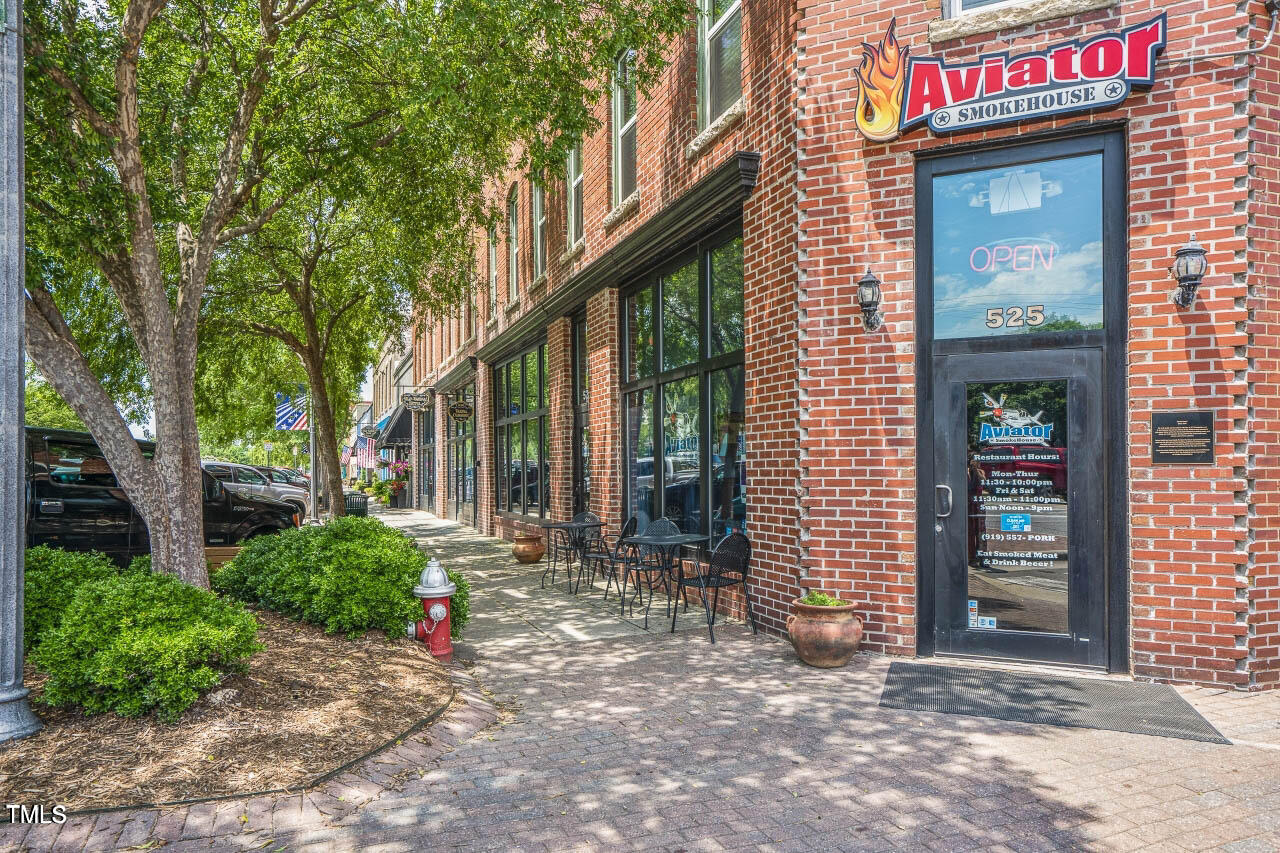771 Old Station Pointe Angier, NC 27501 - Photo 34 of 35 a view of a brick house with large windows and a large tree