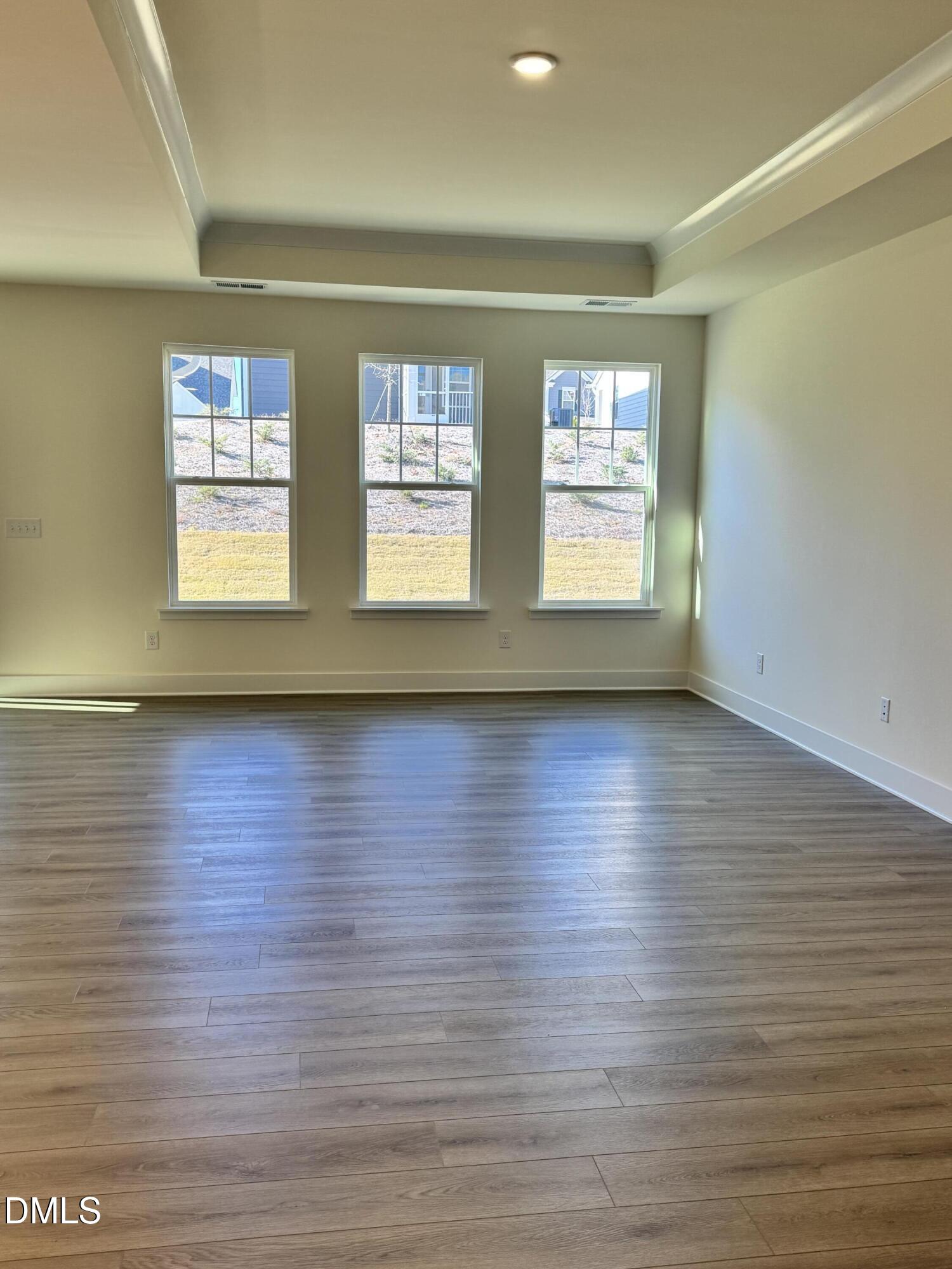 771 Old Station Pointe Angier, NC 27501 - Photo 9 of 35 a view of empty room with wooden floor and fan