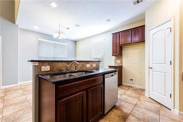 a kitchen with stainless steel appliances granite countertop a stove and a refrigerator