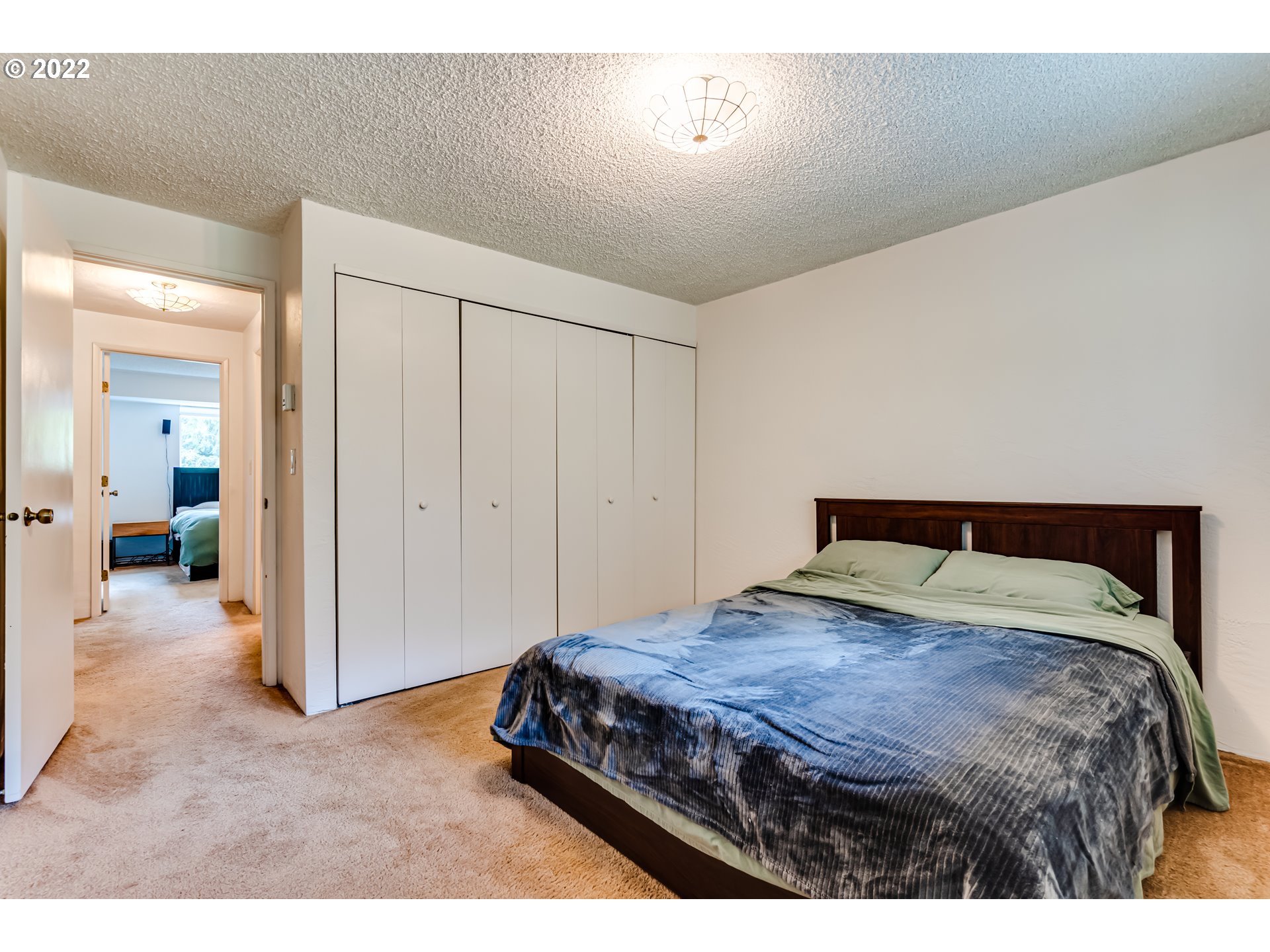 4433 Fox Hollow Road, Unit 1 Eugene, OR 97405 - Photo 18 of 30 a bedroom with a bed and a view of bathroom