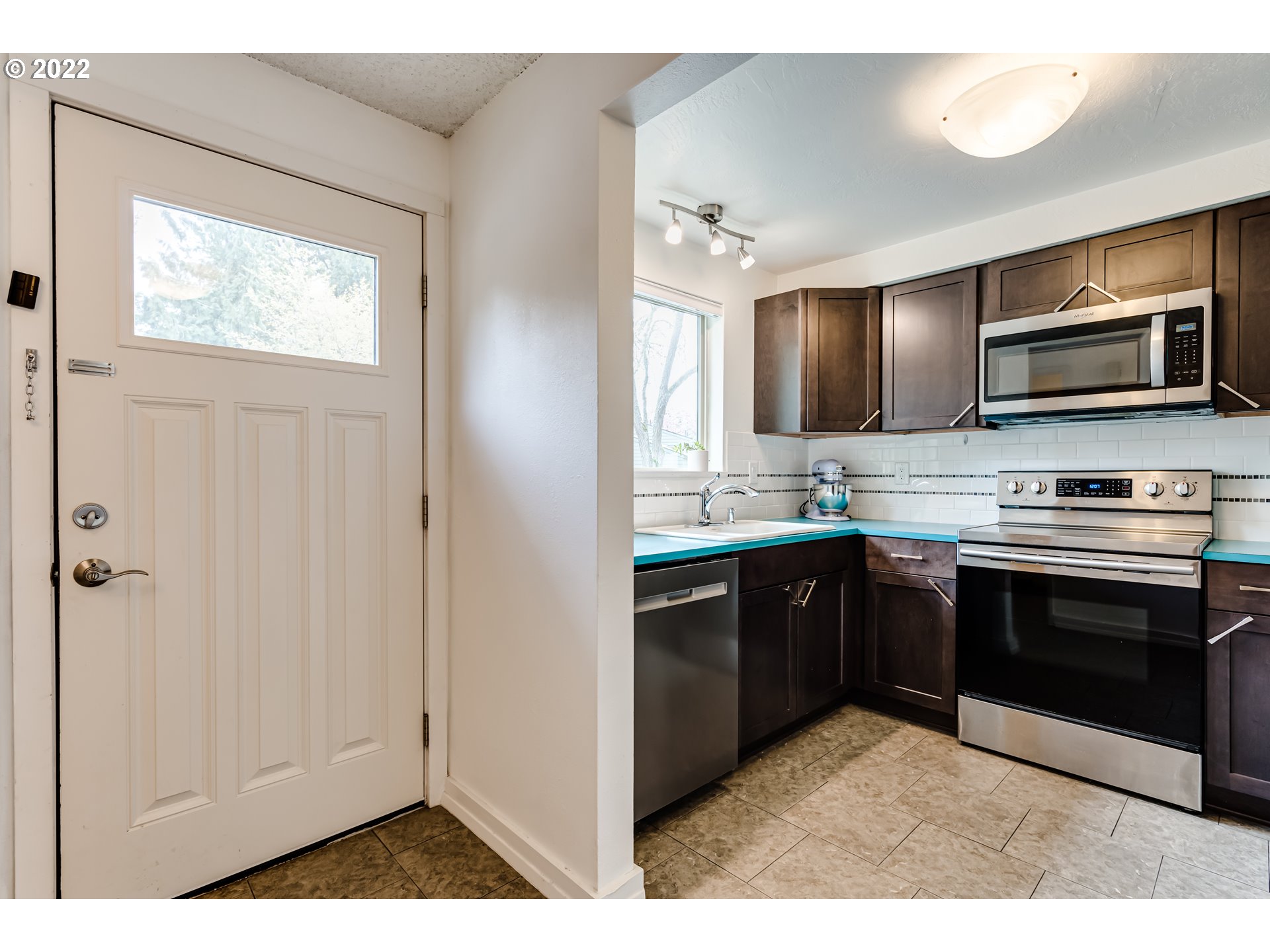4433 Fox Hollow Road, Unit 1 Eugene, OR 97405 - Photo 6 of 30 a kitchen with stainless steel appliances granite countertop a stove and a microwave