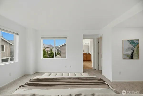 a view of a bedroom with bed and window