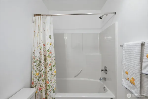 a bathroom with a bathtub and shower