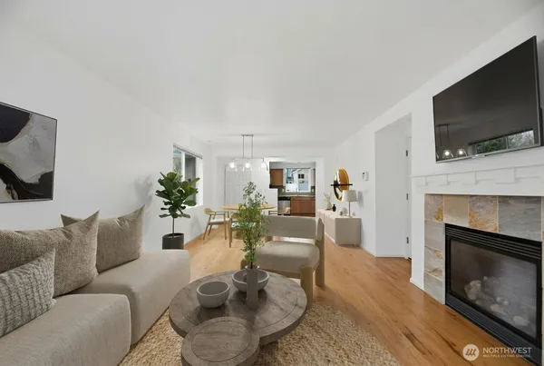 a living room with furniture a flat screen tv and a fireplace