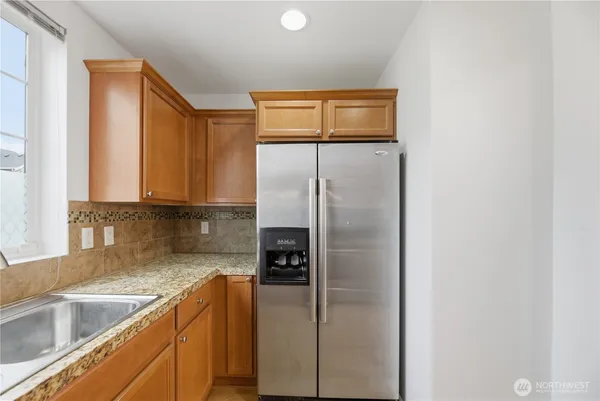 a kitchen with a refrigerator and a sink
