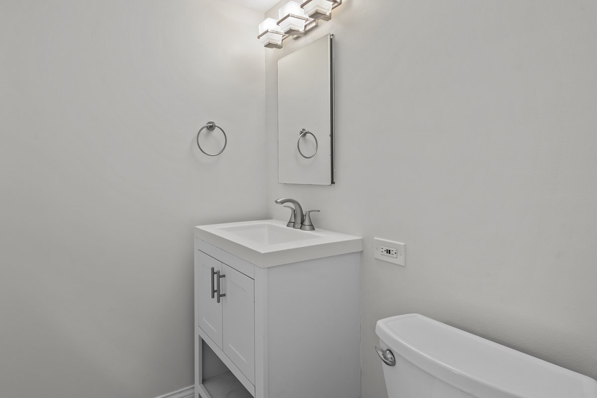 2500 Green Bay Road Highland Park, IL 60035 - Photo 9 of 18 a bathroom with a sink a toilet and a mirror