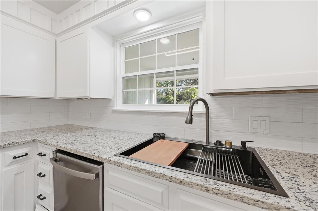 2804 Bent Tree Lane Arlington, TX 76016 - Photo 12 of 32 a kitchen with a sink and a stove top oven