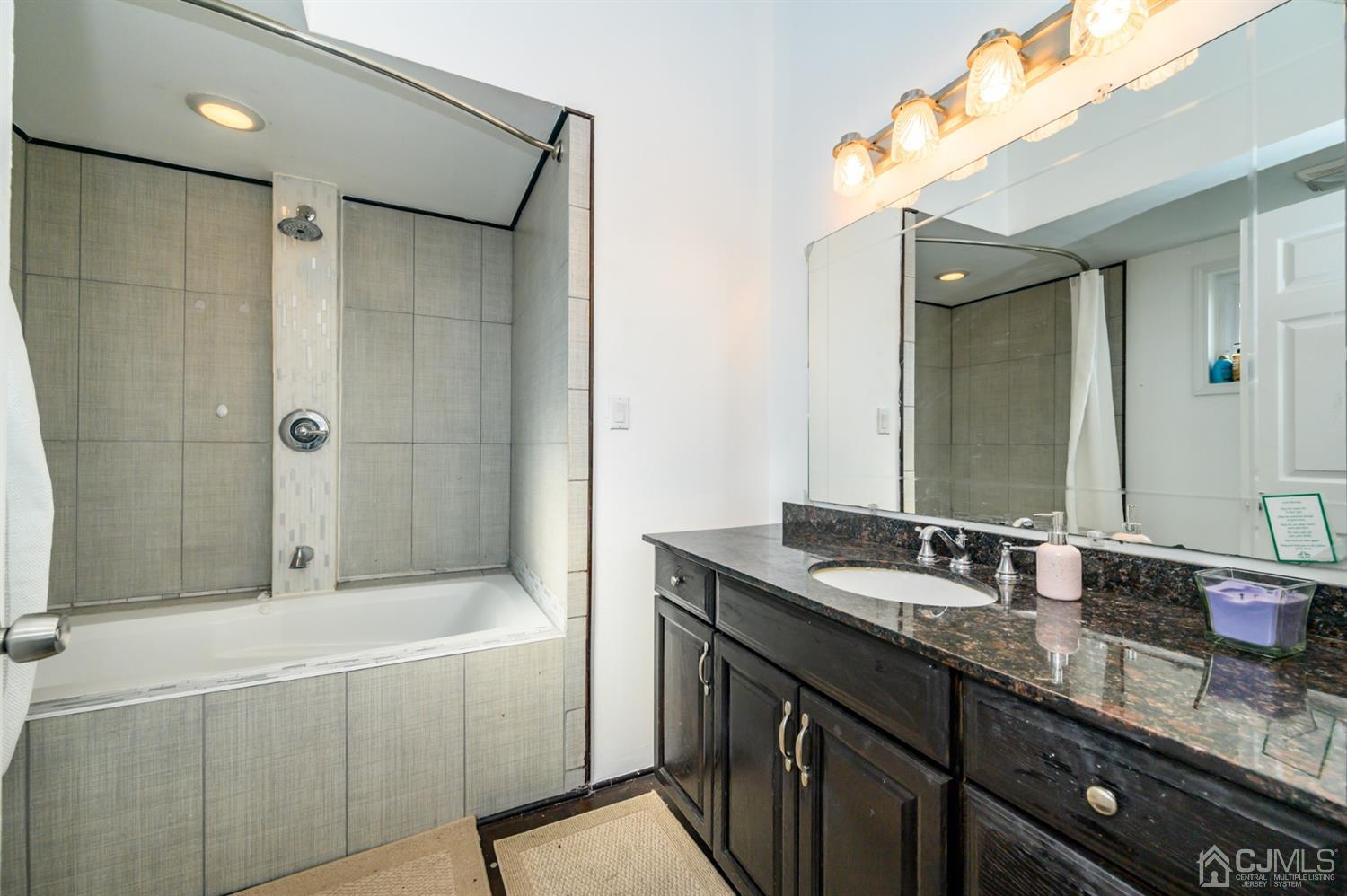 31 Parker Road Long Valley, NJ 07853 - Photo 32 of 46 a bathroom with a granite countertop sink mirror and shower