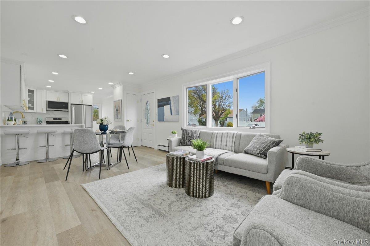 84 North Fordham Road Hicksville, NY 11801 - Photo 2 of 28 a living room with furniture and a dining table with kitchen view