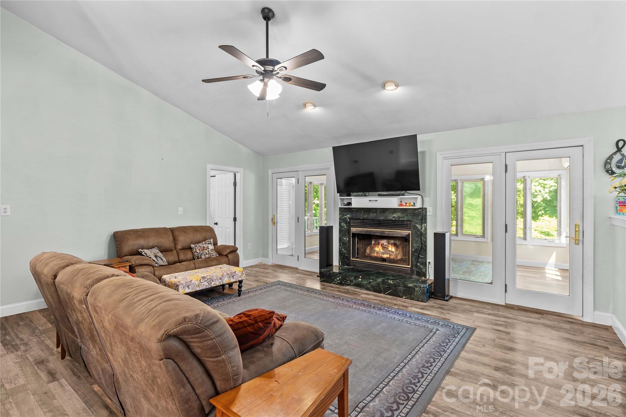 711 Spring Pointe Drive Stony Point, NC 28678 - Photo 5 of 47 a living room with furniture a flat screen tv and a fireplace