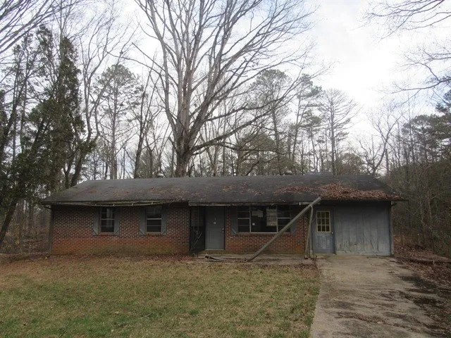 a view of empty room with fireplace and windows
