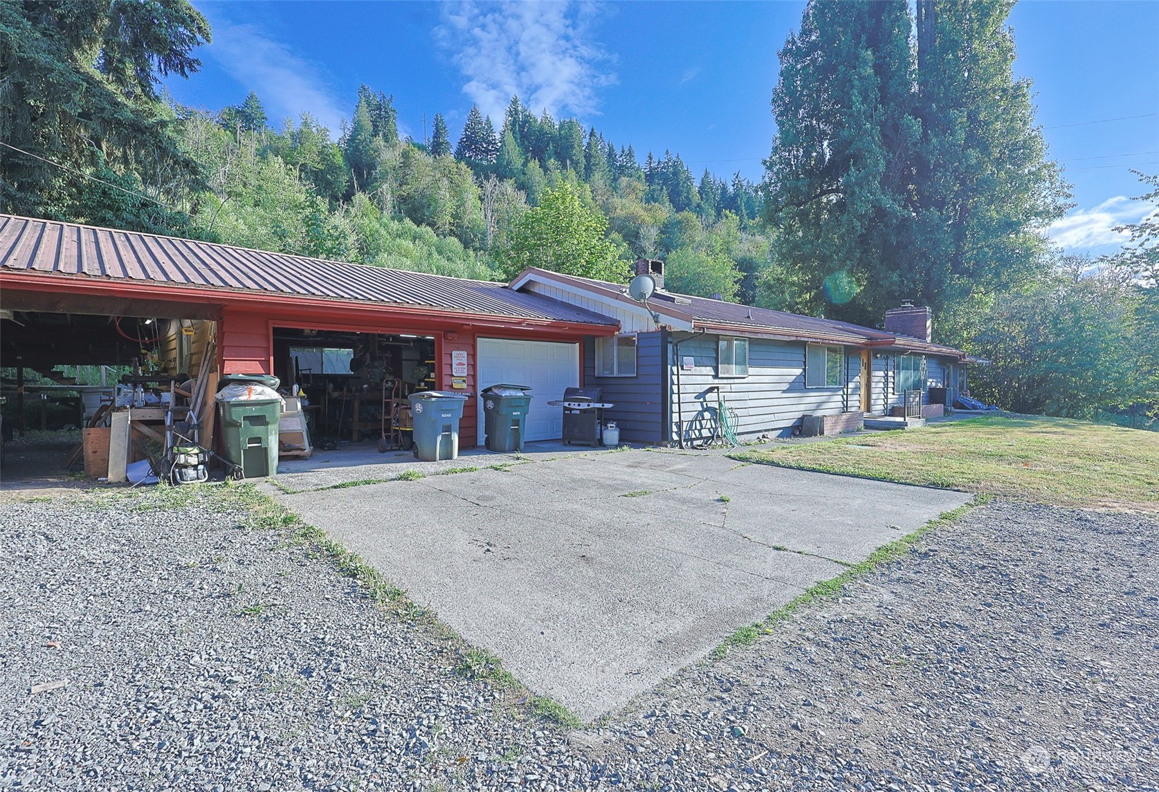 11120 Ohop Valley-Extension Road East Eatonville, WA 98328 - Photo 3 of 32 a front view of a house with a yard and garage