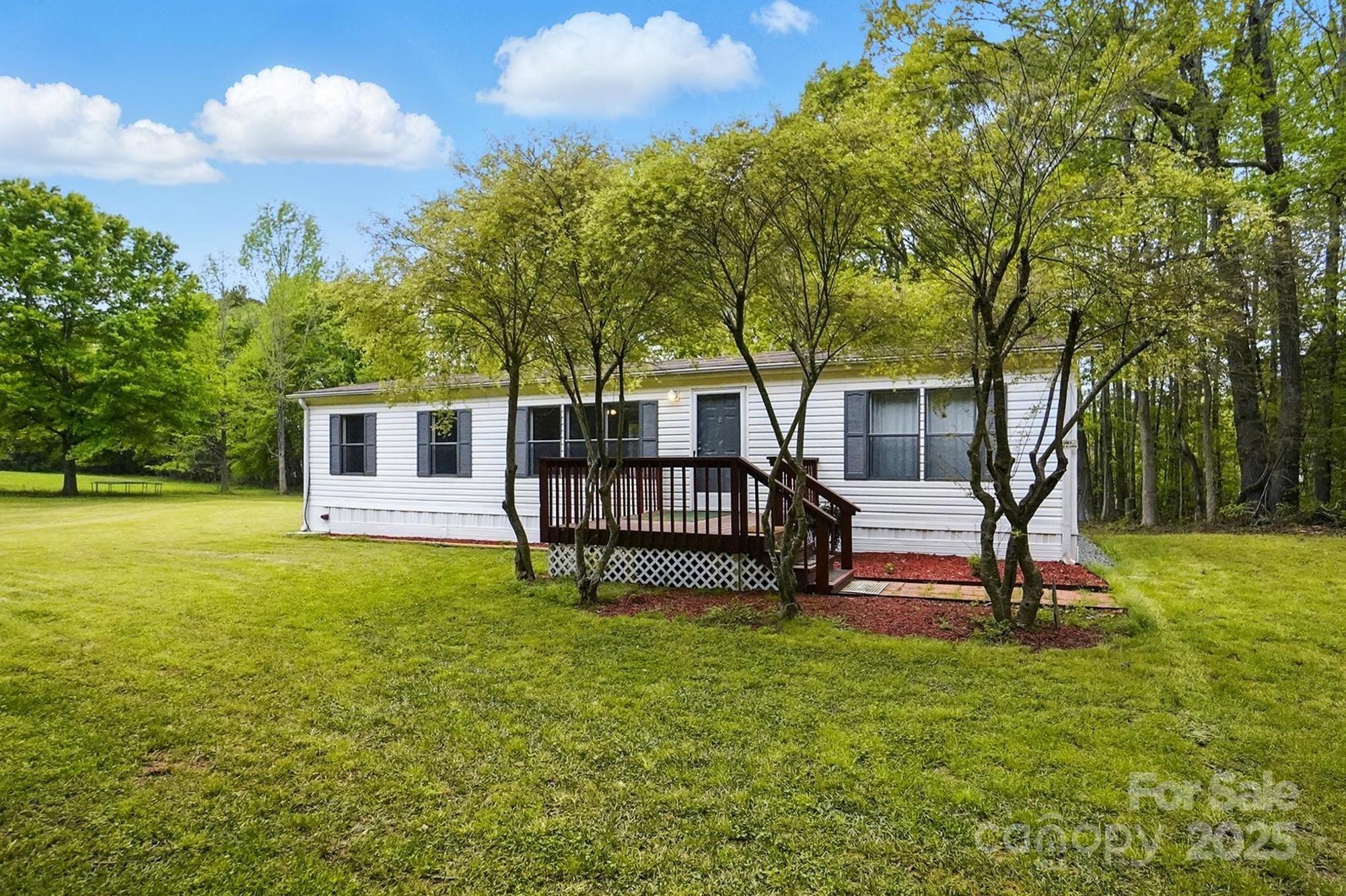 621 Harper Davis Road Lake Wylie, SC 29710 - Photo 1 of 30 a view of a house with a backyard and a tree